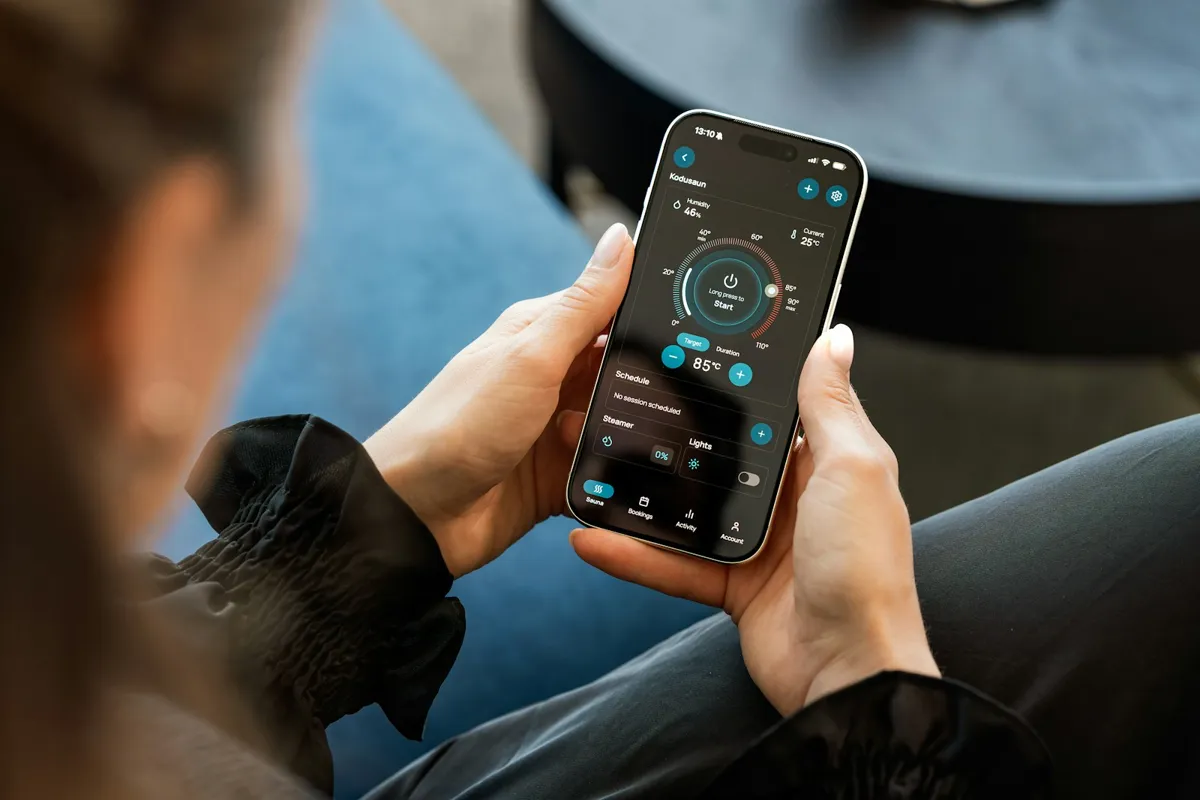 Hands holding a phone with a control app open